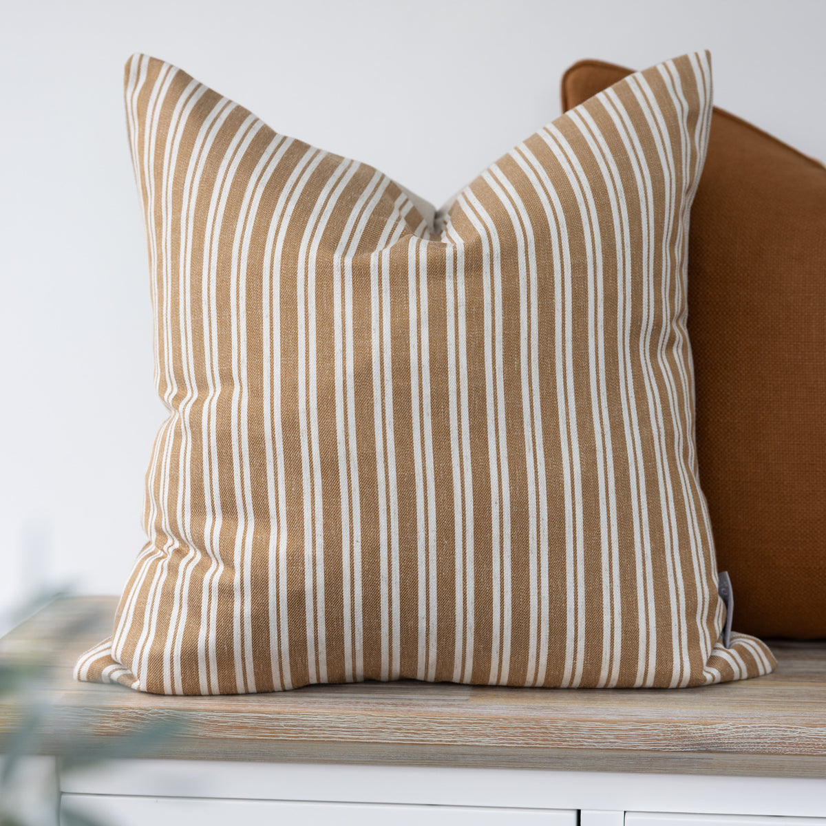 Alderton Ochre Stripe Cushion with narrow cream stripes on a warm ochre background