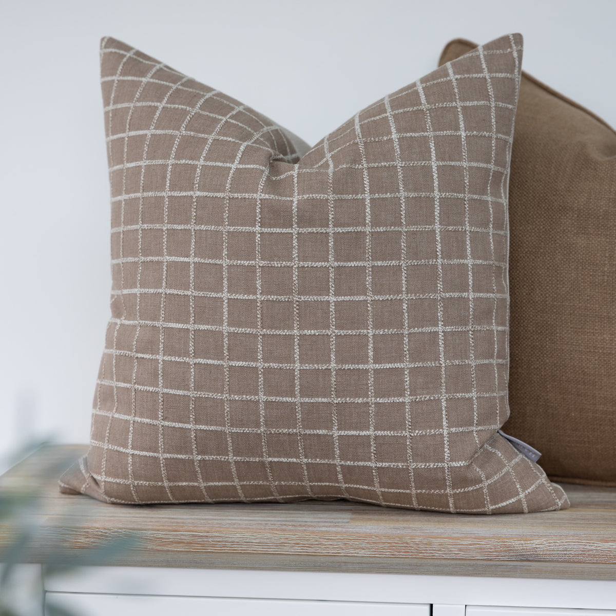 Whitmore Hazelnut Brown Textured Check Cushion with a raised cream windowpane check