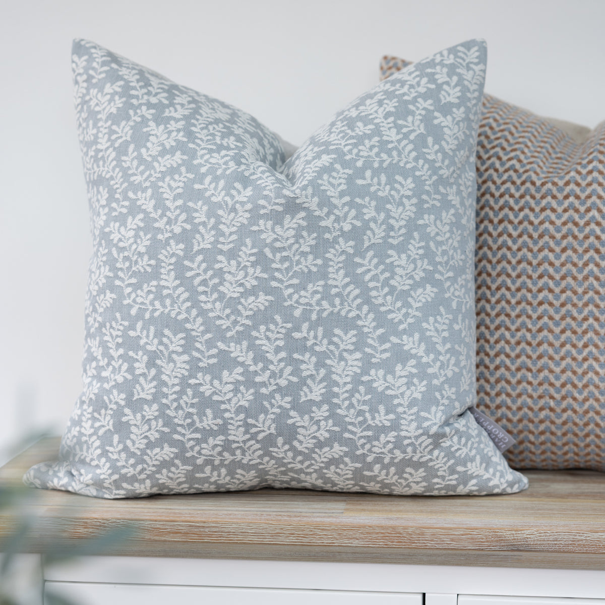 Wychwood Cornflower Blue Leaf Cushion with trailing cream leaves